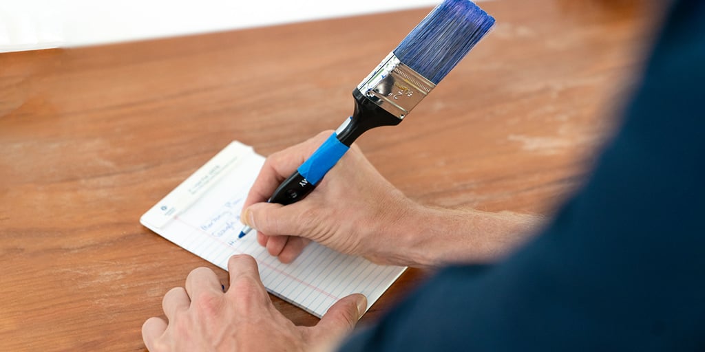 Man writing notes with paint brush pen